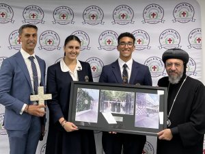 Receiving a gift, with College Principal, Mr Francois David, and the College Captains.